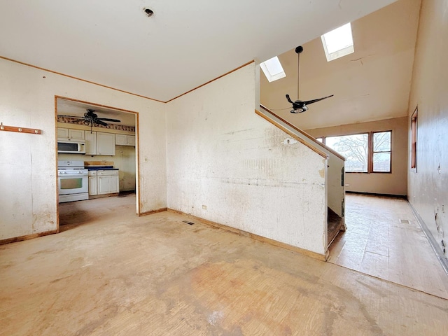 unfurnished living room with ceiling fan and lofted ceiling with skylight