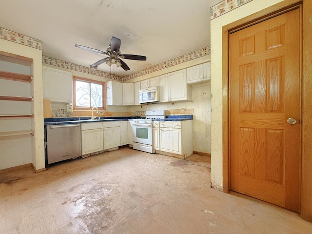 kitchen featuring ceiling fan, sink, and white appliances