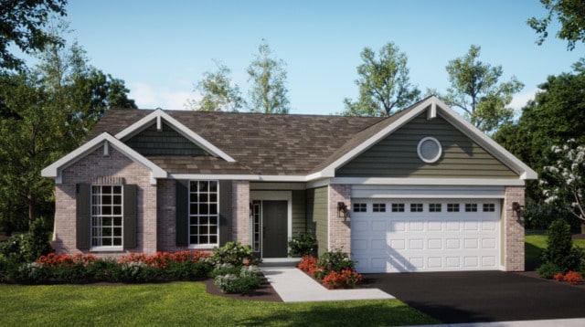 view of front of house featuring a garage and a front lawn