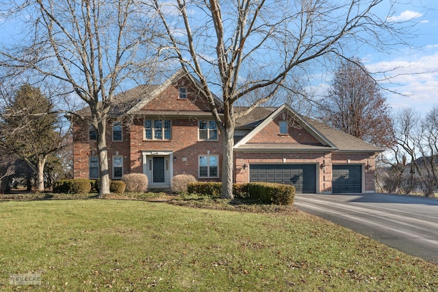 view of front of home with a front lawn and a garage