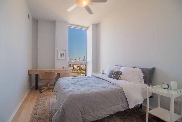 bedroom with hardwood / wood-style floors and ceiling fan