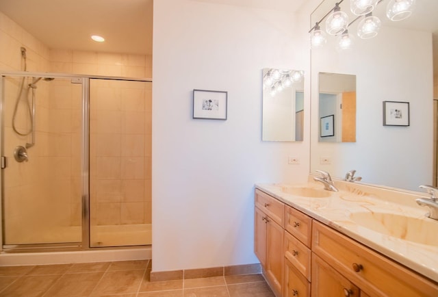 bathroom with tile patterned flooring, vanity, and walk in shower