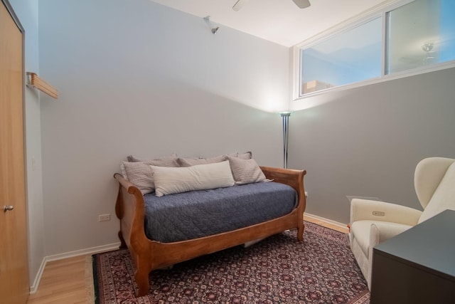 bedroom with hardwood / wood-style floors and ceiling fan