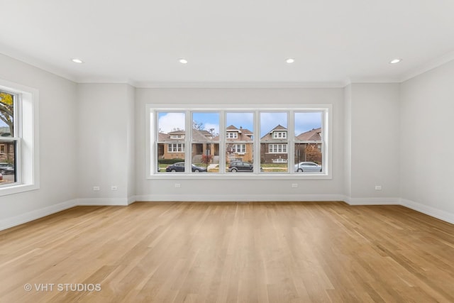 unfurnished room with light hardwood / wood-style flooring and crown molding