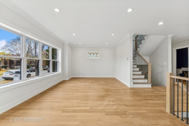 interior space with light hardwood / wood-style floors and crown molding