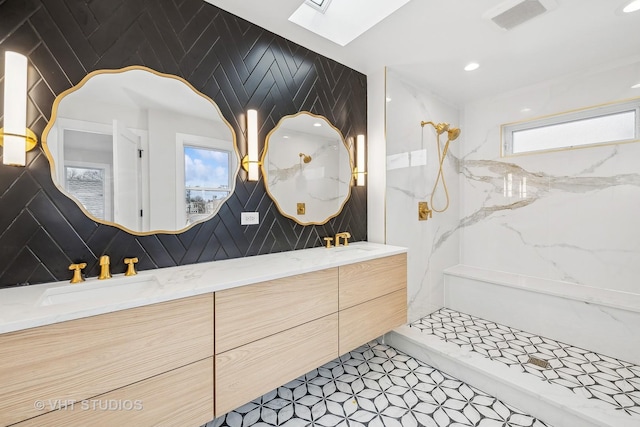 bathroom with tile patterned flooring, a skylight, walk in shower, and vanity