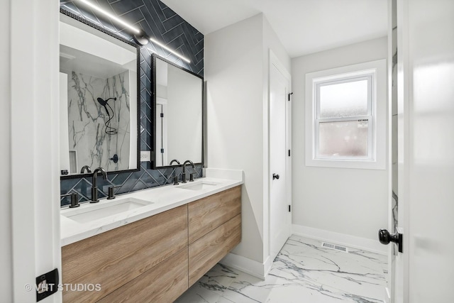 bathroom with vanity and tasteful backsplash