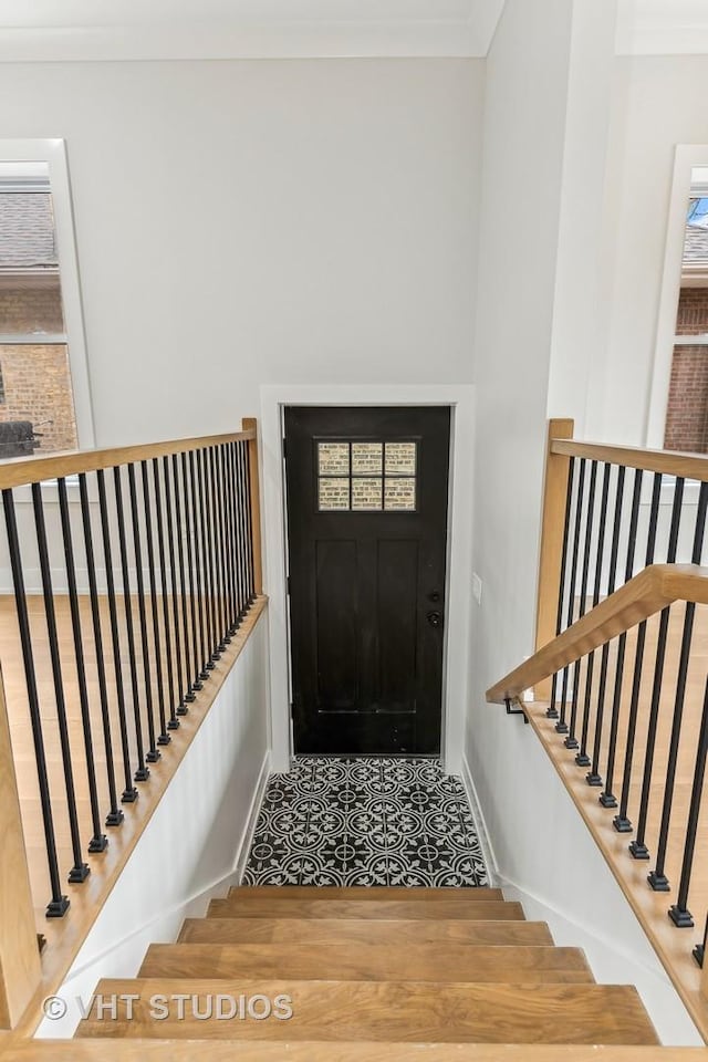 foyer featuring crown molding