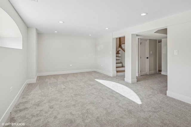 basement featuring light carpet