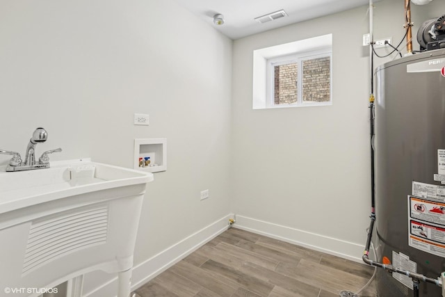 laundry area featuring washer hookup, hardwood / wood-style floors, water heater, and electric dryer hookup