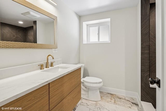 bathroom featuring toilet and vanity