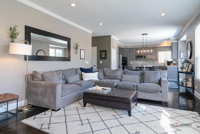 living room with crown molding and light hardwood / wood-style floors