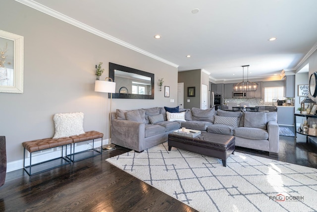 living room with crown molding and hardwood / wood-style floors