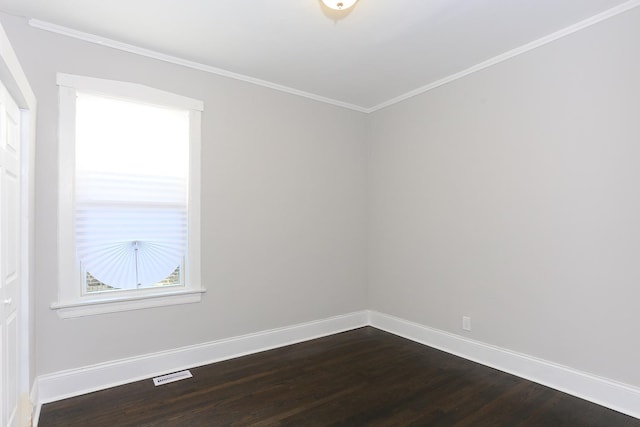 empty room featuring hardwood / wood-style flooring and crown molding