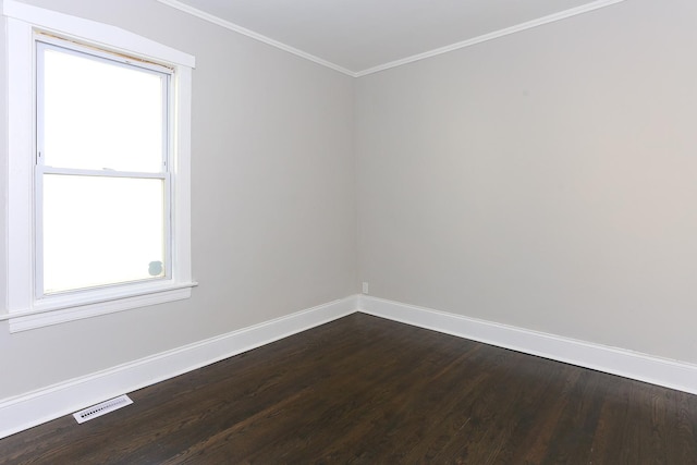 spare room with crown molding, a healthy amount of sunlight, and wood-type flooring