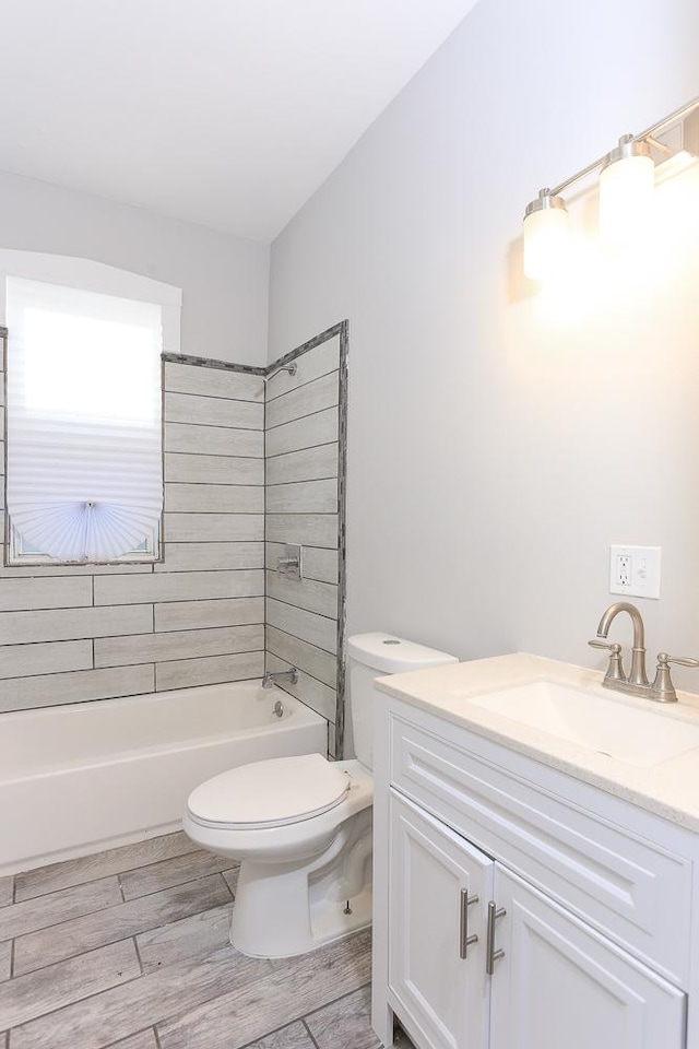 full bathroom with vanity, toilet, and tiled shower / bath combo