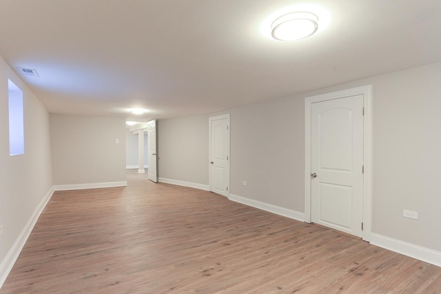 basement with light hardwood / wood-style floors