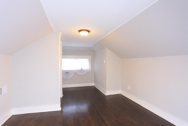 additional living space featuring dark hardwood / wood-style flooring and lofted ceiling