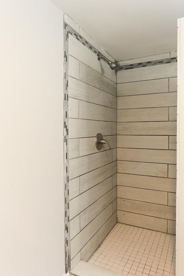 bathroom featuring a shower and wood walls