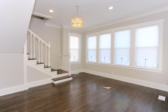 interior space with dark hardwood / wood-style floors, ornamental molding, and an inviting chandelier