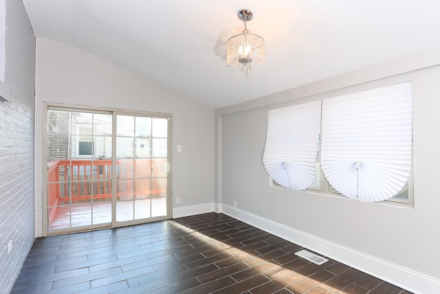 unfurnished room featuring an inviting chandelier and vaulted ceiling