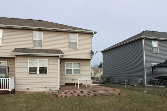 back of property featuring a yard and a deck