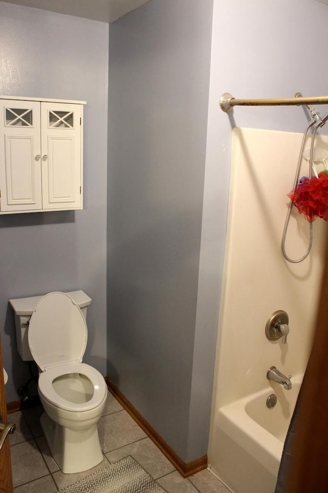 bathroom with tile patterned floors, shower / bathtub combination, and toilet