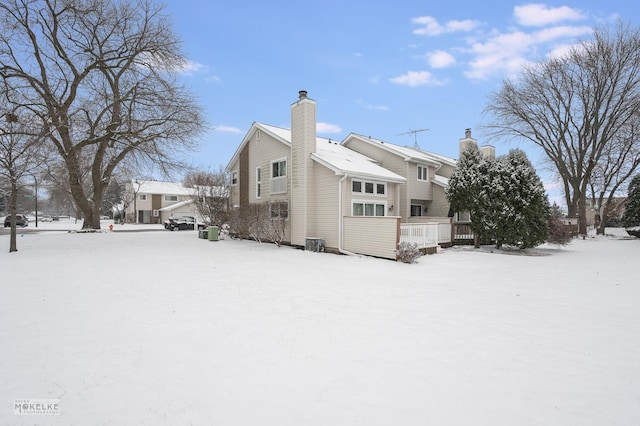 snow covered property featuring a deck