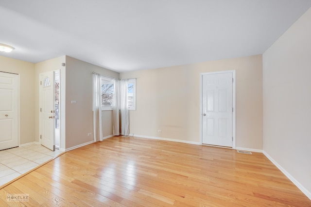 empty room with light hardwood / wood-style floors