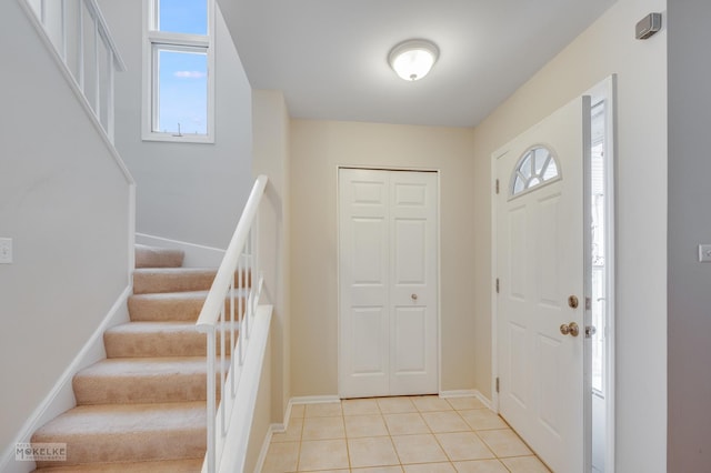 foyer with a wealth of natural light and light tile patterned flooring