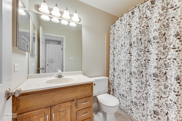 bathroom featuring tile patterned floors, vanity, toilet, and walk in shower