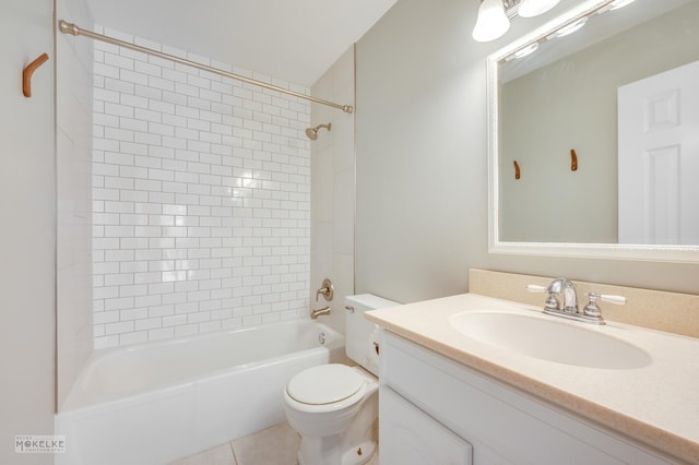 full bathroom with tile patterned flooring, vanity, tiled shower / bath combo, and toilet