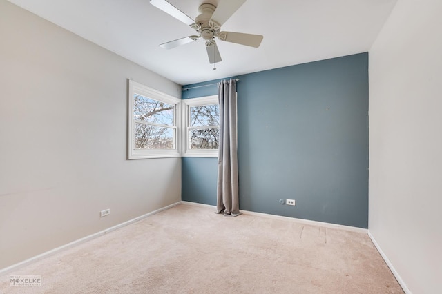 empty room with light colored carpet and ceiling fan