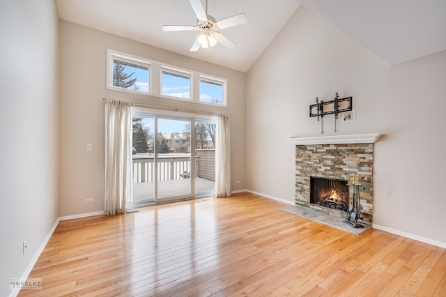 unfurnished living room with ceiling fan, a fireplace, high vaulted ceiling, and light hardwood / wood-style flooring