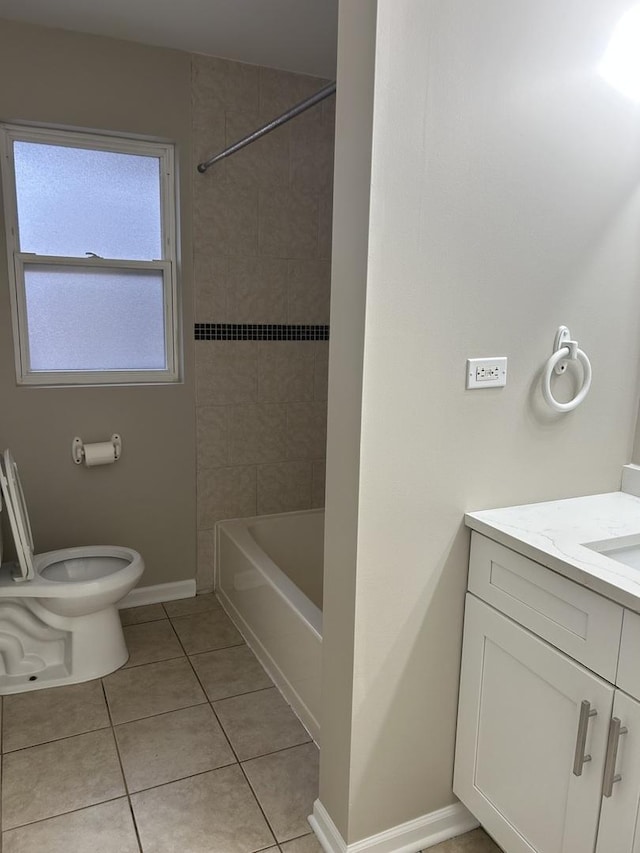 full bathroom with tile patterned flooring, vanity, tiled shower / bath combo, and toilet