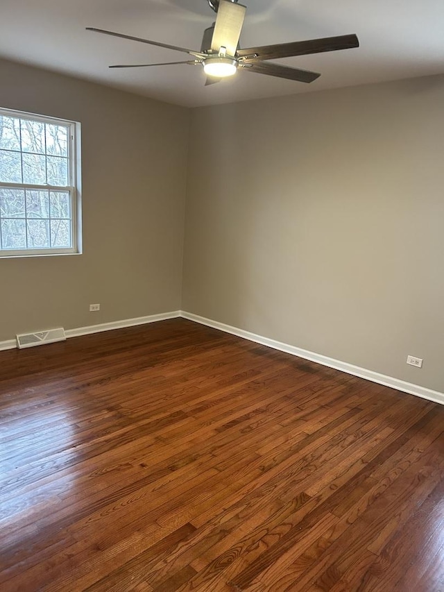 spare room featuring dark hardwood / wood-style floors and ceiling fan