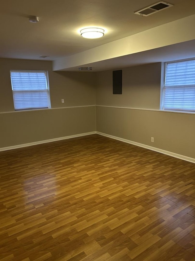 spare room featuring wood-type flooring