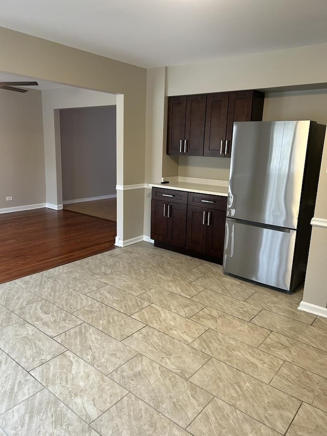 kitchen with stainless steel refrigerator and dark brown cabinetry