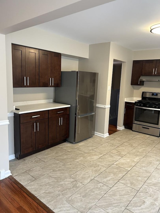 kitchen featuring dark brown cabinetry and appliances with stainless steel finishes