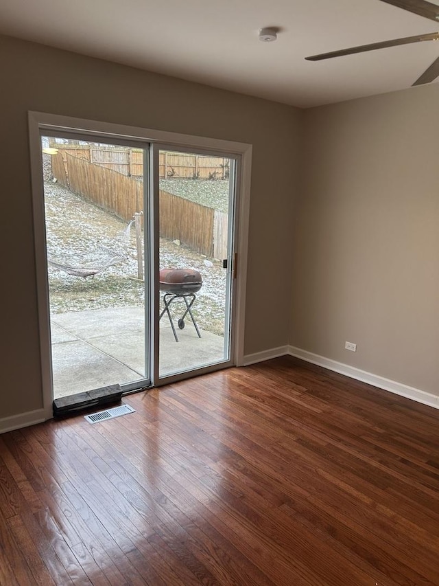 unfurnished room featuring dark hardwood / wood-style flooring and ceiling fan