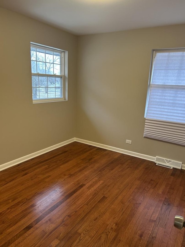 spare room with dark hardwood / wood-style flooring