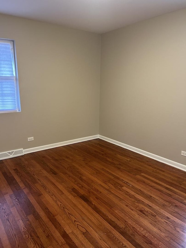 empty room featuring dark hardwood / wood-style flooring