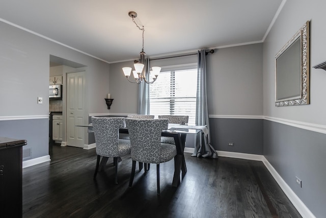 dining room with a notable chandelier, crown molding, and dark wood-type flooring