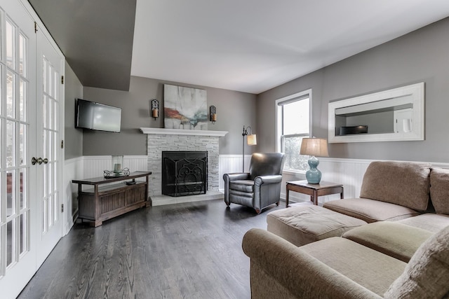 living room featuring a fireplace, french doors, and dark hardwood / wood-style flooring