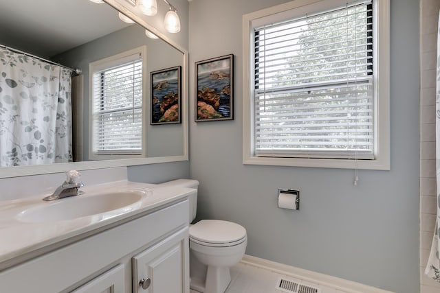 bathroom with tile patterned flooring, vanity, toilet, and a shower with shower curtain