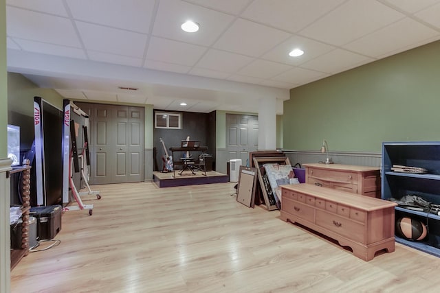 interior space featuring a paneled ceiling and light wood-type flooring