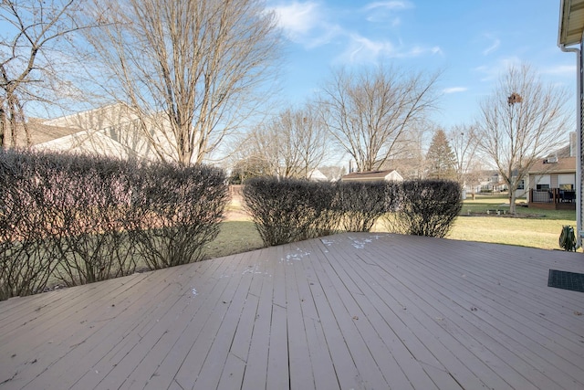 wooden terrace featuring a yard