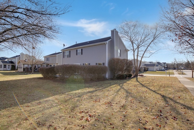 view of side of property featuring a yard