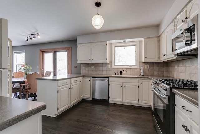 kitchen with white cabinetry, sink, pendant lighting, and appliances with stainless steel finishes