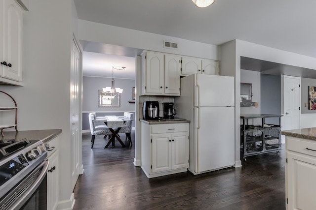 kitchen with white cabinetry, stainless steel electric range oven, and white refrigerator